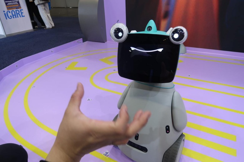 A robot with eyes on top of a screen showing a smile.