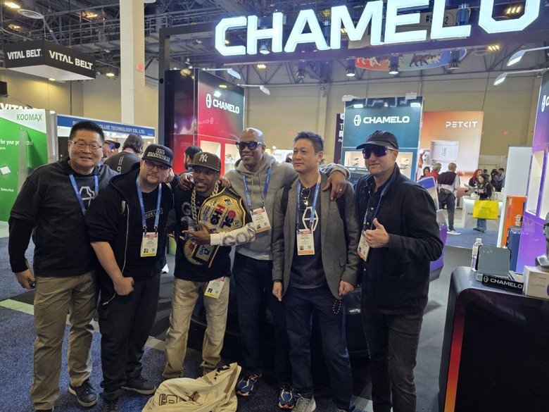 A group of people posing for a picture in front of a booth at CES 2026.