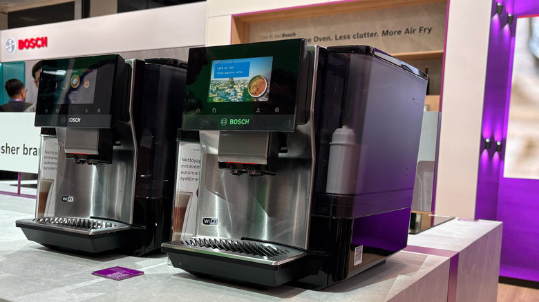 A pair of Bosch coffee makers with displays.