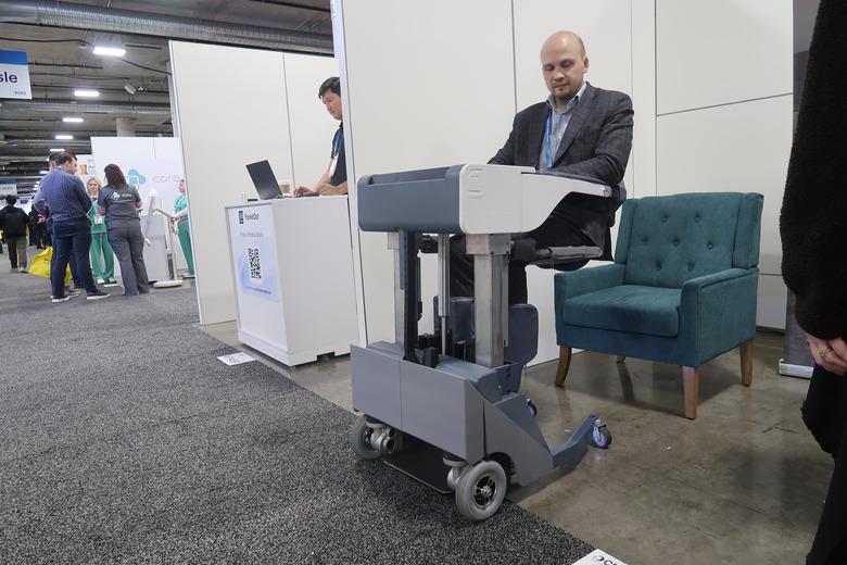 ReviMo founder Aleksandr Malaschenko is pictured demonstrating the Niko lift system at CES