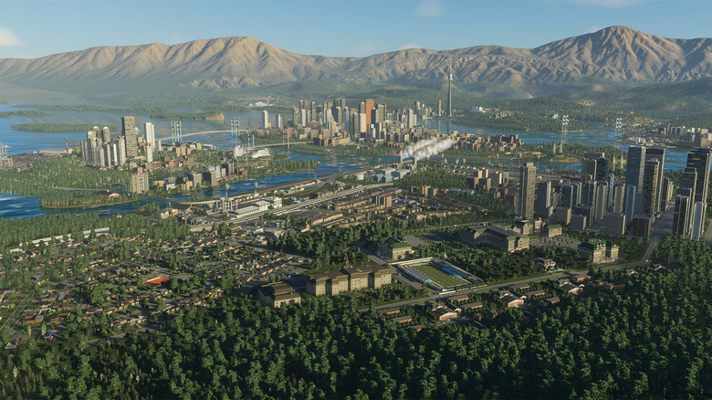 Screenshot from the game City Skylines II, showing a city in front of desert mountains.