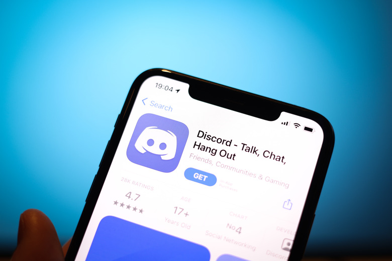 The Discord app is seen on an iPhone in this photo illustration in Warsaw, Poland on April 3, 2021. The communications and messaging platform Discord is reportedly in talks with Microsoft to sell it's platform. According to gaming tech website GamesBeat the sale could result in a USD 10 billion takeover. With over 9 million daily users Discord easily beats workplace messaging app Slack which attracted just over 2 million daily users at it's start. Microsoft could possibly integrate Discord with it's Xbox gaming platform as the app initially became popular with gamers. (Photo by Jaap Arriens/NurPhoto via Getty Images)