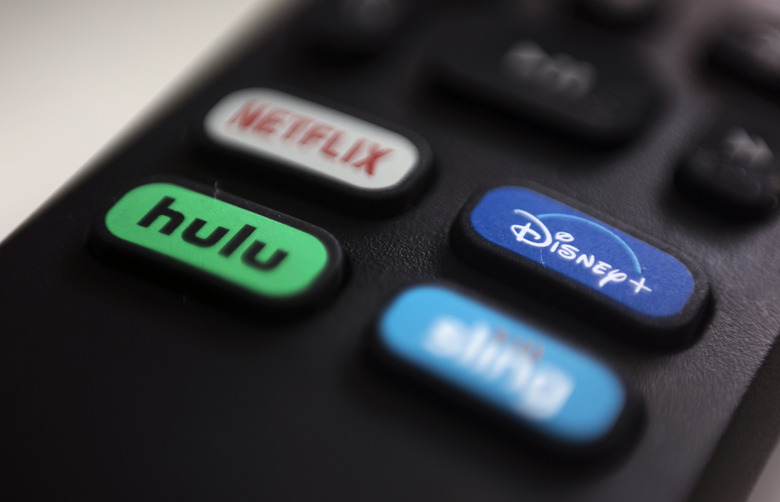 FILE - In this Aug. 13, 2020 file photo, the logos for Netflix, Hulu, Disney Plus and Sling TV are pictured on a remote control in Portland, USA. Streaming high-definition video and games can result in significant greenhouse gas emissions, depending on the technology used, according to a German government-backed study released Thursday. (AP Photo/Jenny Kane)