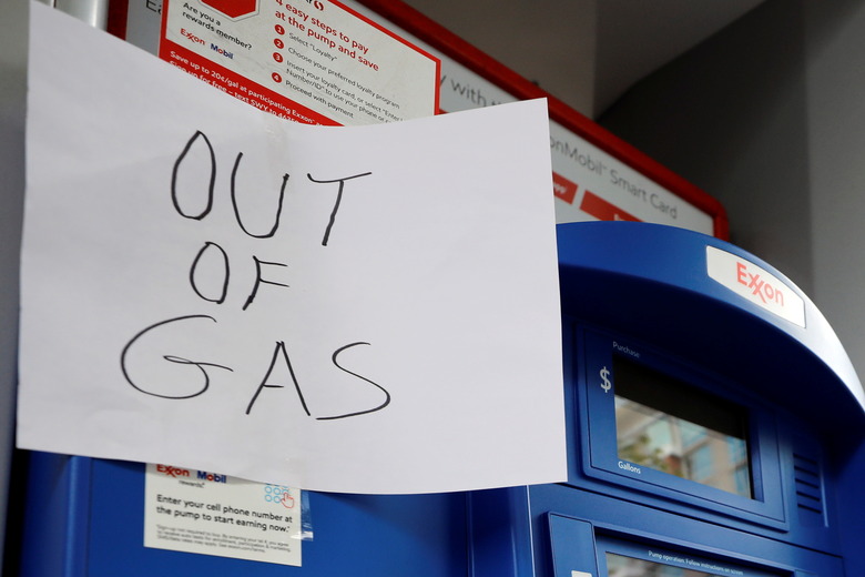 A sign is seen as Exxon station is out of gas after a cyberattack crippled the biggest fuel pipeline in the country, run by Colonial Pipeline, in Washington, U.S., May 15, 2021. REUTERS/Yuri Gripas