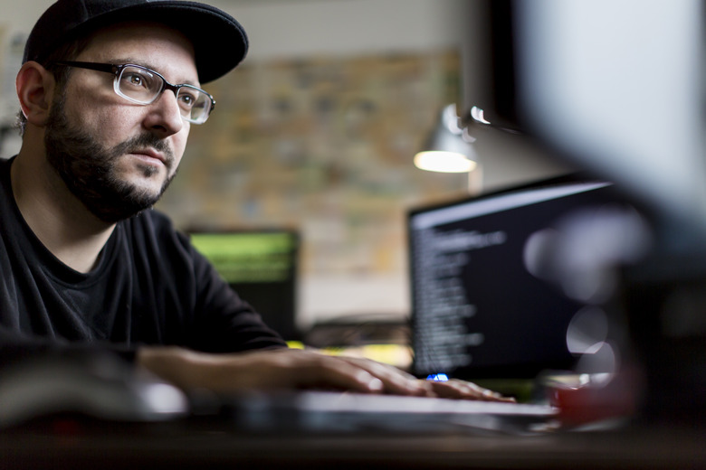 caucasian hacker stealing information from computer