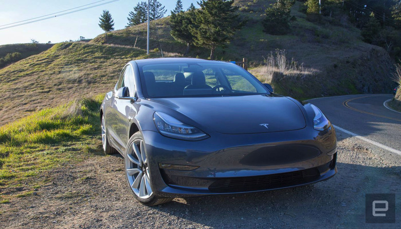 Tesla EV on the side of a road.