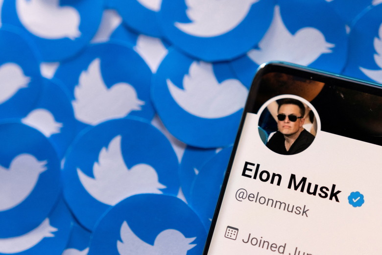 Elon Musk's Twitter profile is seen on a smartphone placed on printed Twitter logos in this picture illustration taken April 28, 2022. REUTERS/Dado Ruvic/Illustration