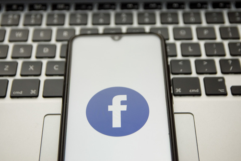 In this photo illustration a Facebook logo seen displayed on a smartphone screen with a computer keyword in the background in Athens, Greece on January 18, 2022. ( (Photo illustration by Nikolas Kokovlis/NurPhoto via Getty Images)