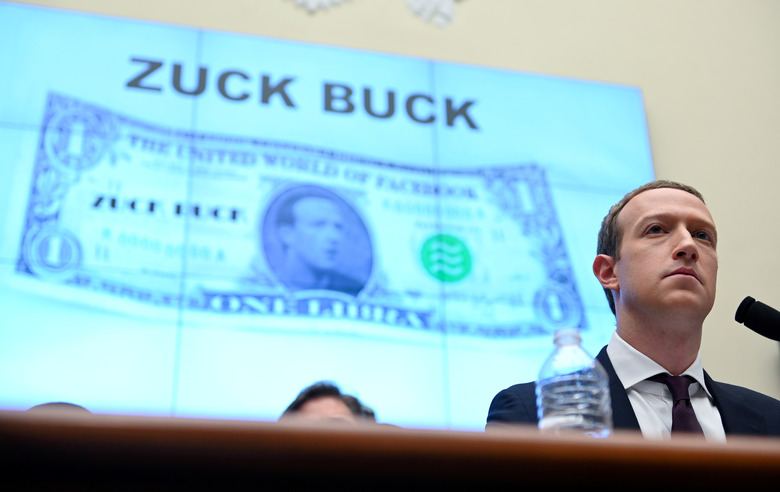 Facebook Chairman and CEO Mark Zuckerberg testifies in front of a projection of a 