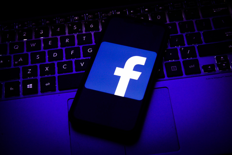 Logo of Facebook displayed on a smartphone screen and keyboard are seen in this illustration photo taken in Krakow, Poland on August 11, 2020. (Photo Illustration by Jakub Porzycki/NurPhoto via Getty Images)