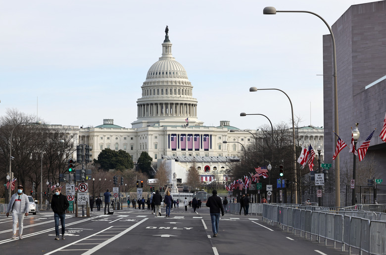 WASHINGTON, DC - JANUARY 16: Pedestrians walk along Pennsylvania Avenue near the U.S. Capitol on January 16, 2021 in Washington, DC. After last week's riots at the U.S. Capitol Building, the FBI has warned of additional threats in the nation's capital and in all 50 states. According to reports, as many as 25,000 National Guard soldiers will be guarding the city as preparations are made for the inauguration of Joe Biden as the 46th U.S. President. (Photo by Michael M. Santiago/Getty Images)