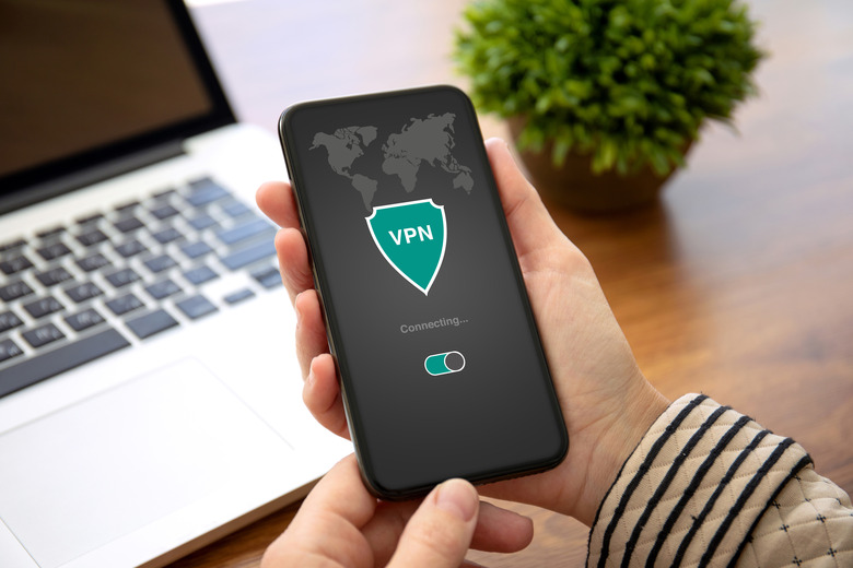 female hands holding phone with app vpn creation Internet protocols for protection private network in the office