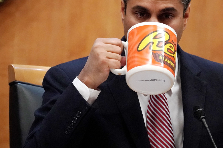 WASHINGTON, DC - DECEMBER 14:  Federal Communications Commission Chairman Ajit Pai drinks from a big coffee cup during a commission meeting December 14, 2017 in Washington, DC. The FCC is scheduled to vote on a proposal to repeal net-neutrality.  (Photo by Alex Wong/Getty Images)