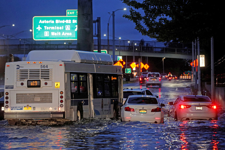 A bus navigates past abandoned cars on a flooded highway, as local media reported the remnants of Tropical Storm Ida bringing drenching rain and the threat of flash floods and tornadoes to parts of the northern mid-Atlantic, in the Queens borough of New York City, U.S., September 2, 2021.  