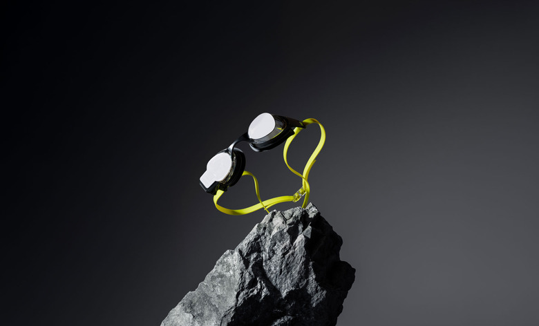 Promotional image of the Form Smart Swim 2 Pro floating over a rock on a dark background.