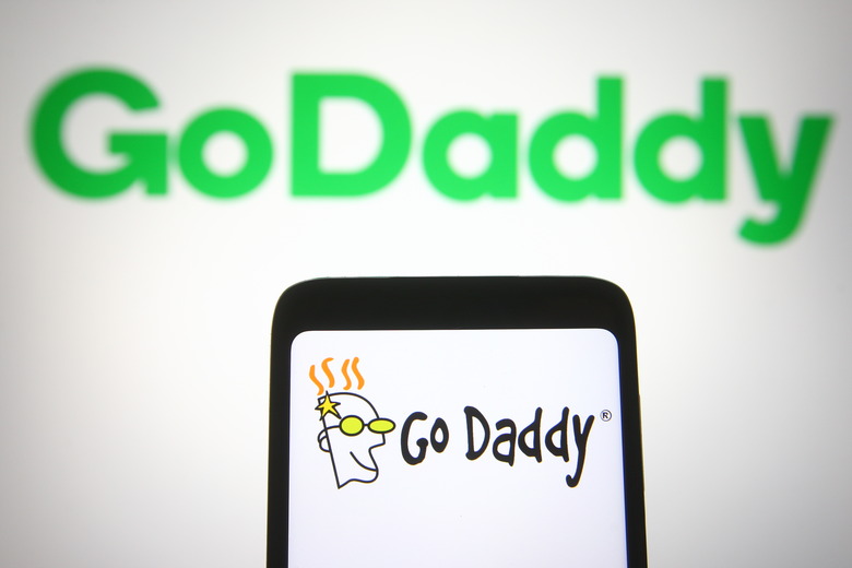 UKRAINE - 2021/04/07: In this photo illustration the GoDaddy logo is seen on a smartphone and a pc screen. (Photo Illustration by Pavlo Gonchar/SOPA Images/LightRocket via Getty Images)