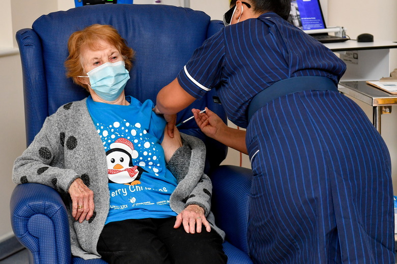 Margaret Keenan, 90, is the first patient in Britain to receive the Pfizer/BioNtech COVID-19 vaccine at University Hospital, administered by nurse May Parsons, at the start of the largest ever immunisation programme in the British history, in Coventry, Britain December 8, 2020. Britain is the first country in the world to start vaccinating people with the Pfizer/BioNTech vaccine. Jacob King/Pool via REUTERS/File Photo     TPX IMAGES OF THE DAY      SEARCH 