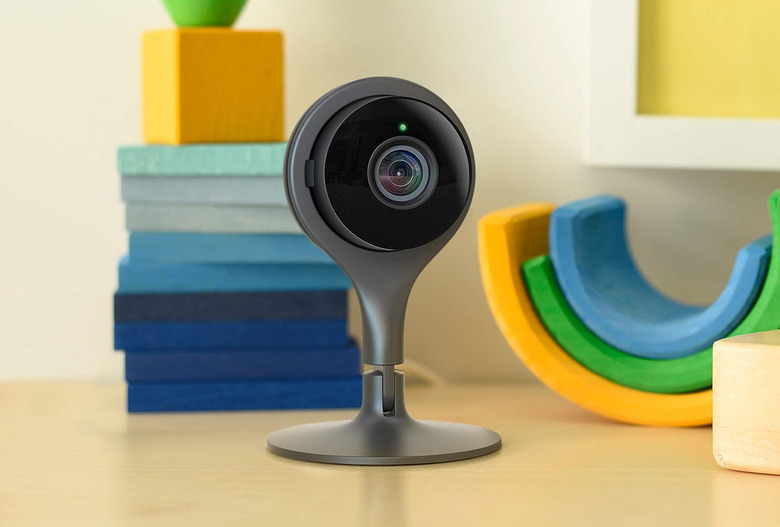 A security camera on top of a table with blocks in the background.