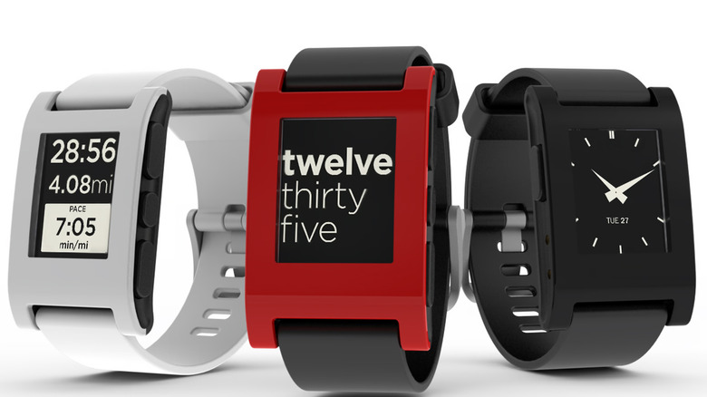 Three Pebble smartwatches side-by-side.