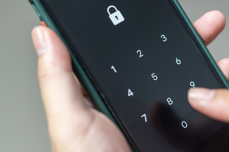Hacking mobile phone with a password to access a smartphone, security threats online Phone lock code. Smartphone protection with 2fa Smartphone protection and security with pin number. Encrypted data.
