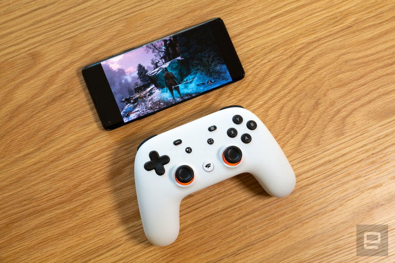 Image of a Google Stadia Pro controller and phone playing a video game mobile entertainment system title for a story discussing how Stadia Pro now offers 30 minute free trials without the need to offer payment information.