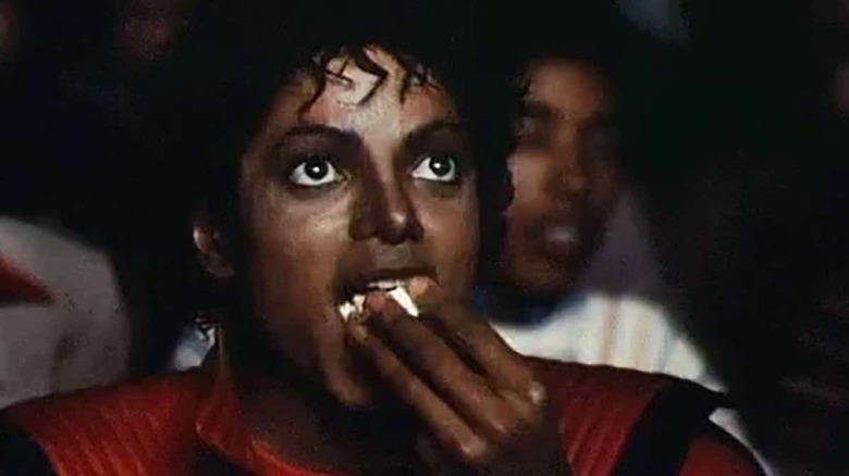 Michael Jackson eating popcorn in a movie theater