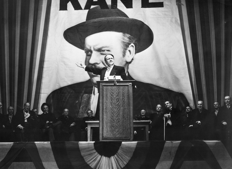 Charles Foster Kane (Orson Welles) makes a stirring campaign speech before a larger-than-life portrait of himself in a scene from Citizen Kane.