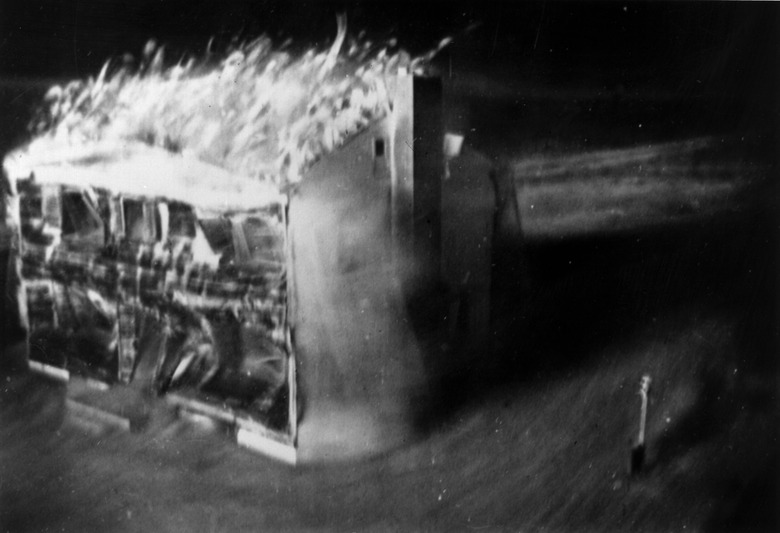 Atom bomb tests in Nevada. The destruction is photographed by a motion picture camera located 60 feet from the doomed house, which is encased in a two inch deep lead sheath.  It shoots 24 frames per second - the time from the first to the last picture (eight were taken) was only 2 1/3 seconds.  The only source of light was the atom bomb. Original Artwork: Image by Edgerton, Getrmeshausen and Grier Inc. for AEC.   (Photo by Keystone/Getty Images)