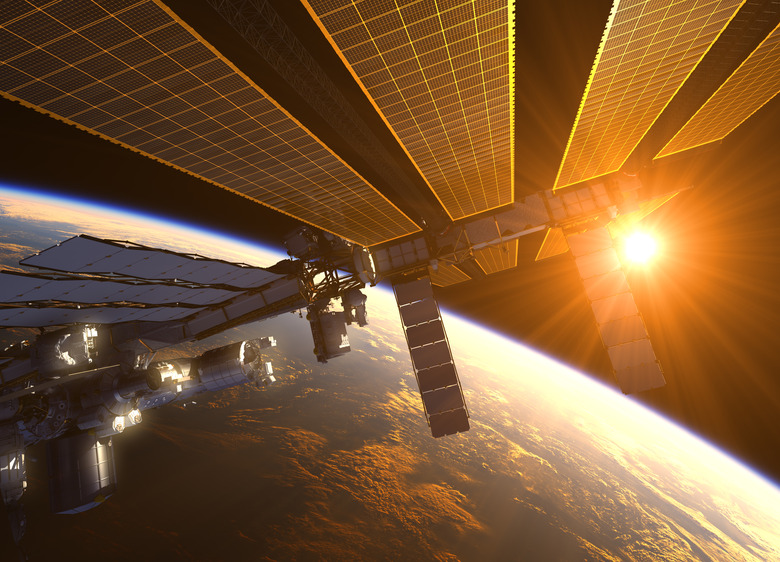 International Space Station In The Rays Of Red Sun. 3D Illustration.