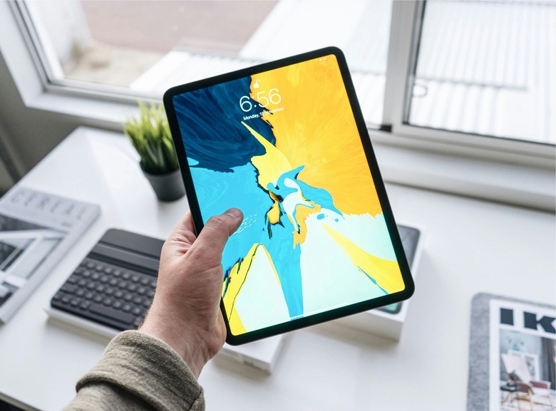 A man holding an iPad.