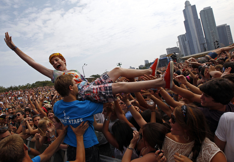 A music fan crowd surfs during a performance by 