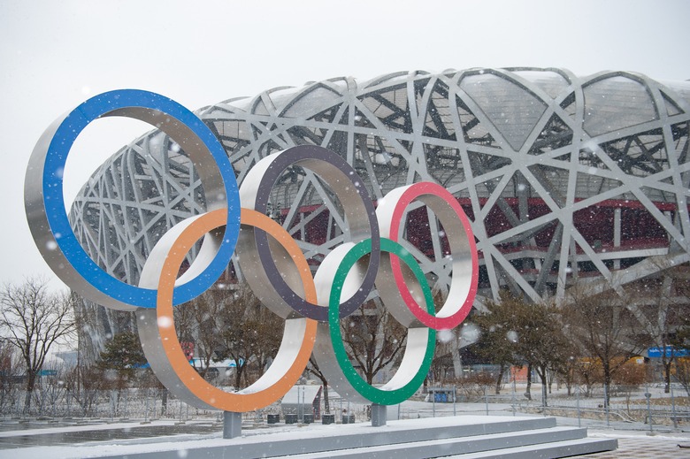 Photo taken on Jan. 20, 2022 shows the Olympic rings and the National Stadium amid snowfall in Beijing, capital of China. (Photo by Chen Zhonghao/Xinhua via Getty Images)