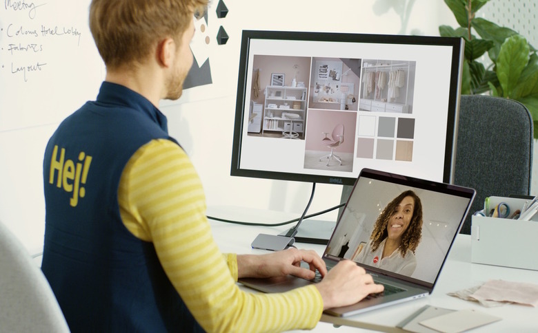 An IKEA worker talks over video chat with a customer while looking at different room options.
