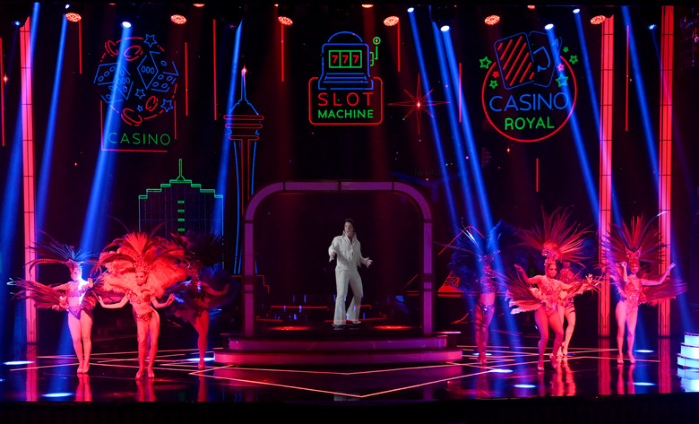 LAS VEGAS, NEVADA - NOVEMBER 28:  Cast members perform with a hologram of Elvis Presley during the 