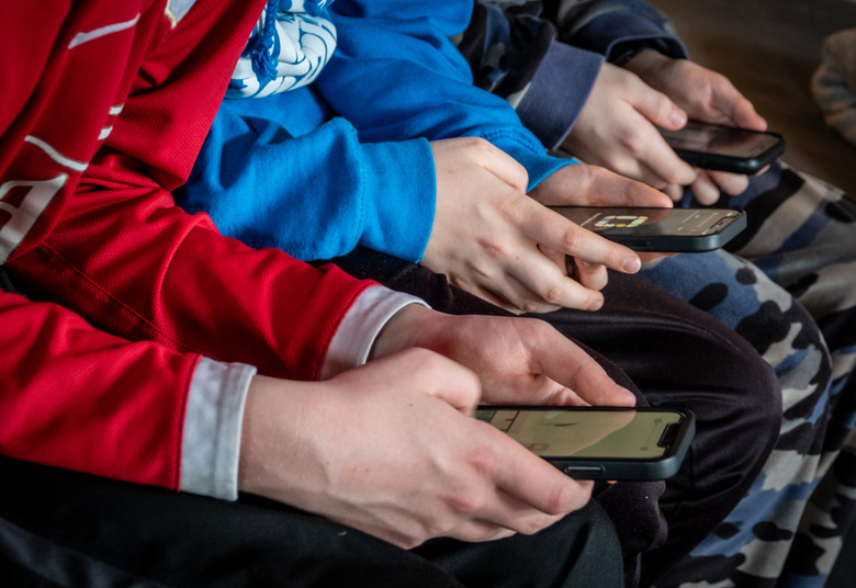 MORZINE, FRANCE - APRIL 08: Three teenage boys looks at their smartphone screens in village of St Jean d'Aulps on April 8, 2024 near Morzine, France.
Following the lead of the EU Commission and several US administrations, TikTok is set to be banned from UK government phones amid security concerns around the Chinese-owned video app. Recently TikTok announced that every account belonging to a user below age 18 have a 60-minute daily screen time limit automatically set. (Photo by Matt Cardy/Getty Images)