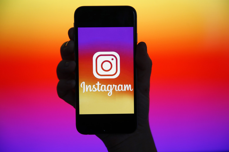 PARIS, FRANCE - DECEMBER 26: In this photo illustration, the Instagram logo is displayed on the screen of an iPhone on December 26, 2019 in Paris, France. Instagram is an application, a social network and a photo and video sharing service founded and launched in October 2010 by the American Kevin Systrom and the Brazilian Michel Mike Krieger. (Photo by Chesnot/Getty Images)