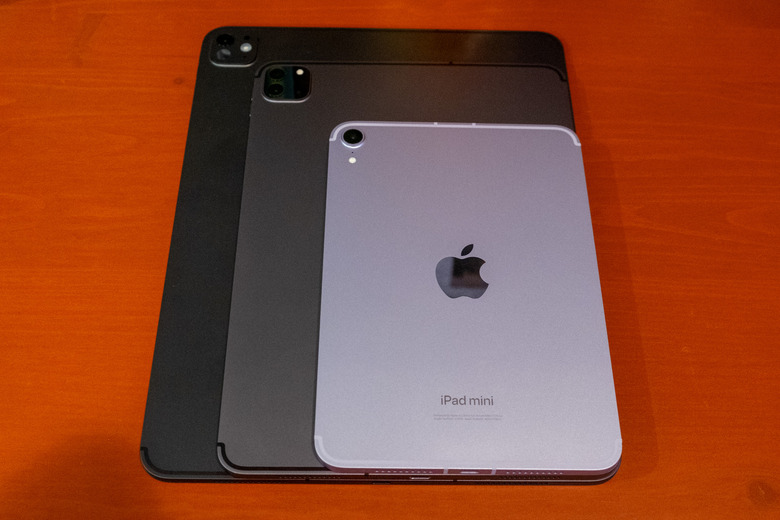 The iPad mini, on top of an 11-inch iPad Pro, on top of a 13-inch iPad Pro.