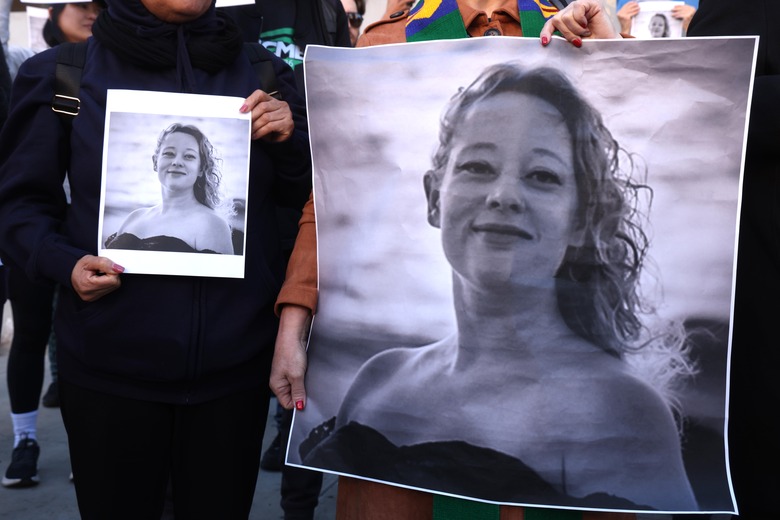 LOS ANGELES, CA - JANUARY 8, 2026 Dozens, holding photos of Renee Nicole Good, protest her death a day after an ICE agent killed Good in Minneapolis, in front of the Federal Building in downtown Los Angeles on January 8, 2026. (Genaro Molina/Los Angeles Times via Getty Images)