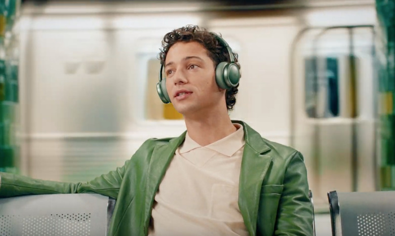 A guy wearing headphones with a matching jacket for some reason.
