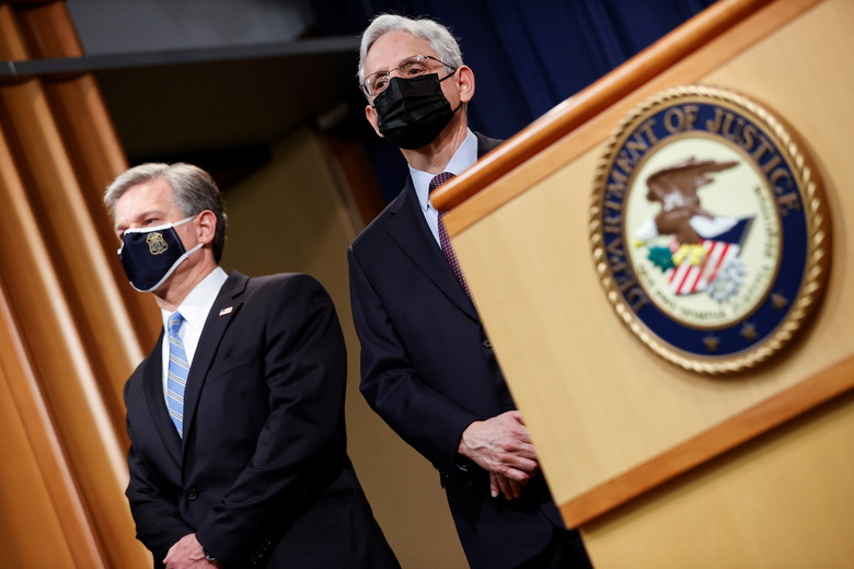 FBI Director Christopher Wray and U.S. Attorney General Merrick Garland face reporters as they announce charges against a suspect from Ukraine and a Russian national over a July ransomware attack on an American company, during a news conference at the Justice Department in Washington, U.S., November 8, 2021. REUTERS/Jonathan Ernst