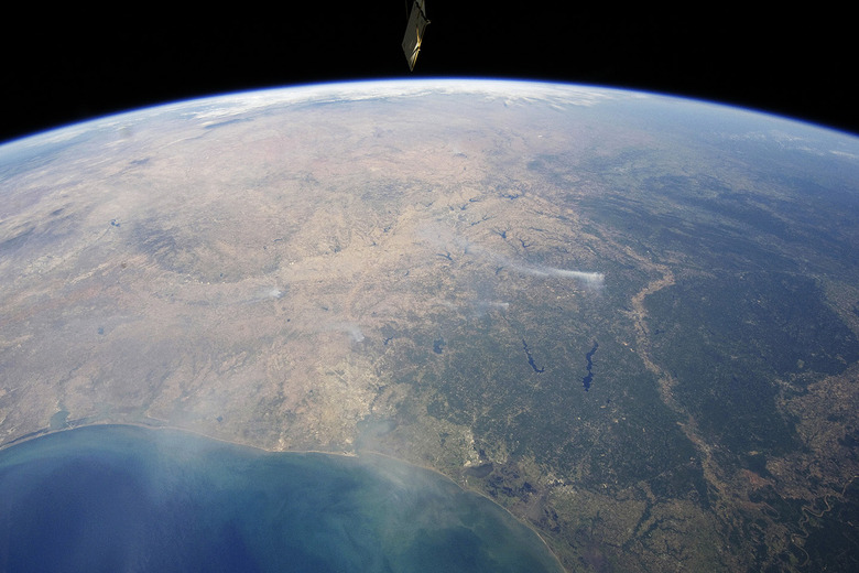 A panoramic view taken by astronauts aboard the International Space Station (ISS) of east-central Texas on September 6, 2011, highlights numerous smoke plumes caused by wildfires burning across the state. Smoke plumes are clearly visible to the east of Austin; to the north of Houston; to the northwest of Lake Sam Rayburn and Toledo Bend Reservoir; and to the west of Shreveport, Louisiana. Diffuse smoke is moving offshore into the Gulf of Mexico at image bottom. Part of an ISS photovoltaic radiator panel is visible at image top center. Picture taken September 6, 2011. REUTERS/Nasa Earth Observatory/Handout (ENVIRONMENT) FOR EDITORIAL USE ONLY. NOT FOR SALE FOR MARKETING OR ADVERTISING CAMPAIGNS. THIS IMAGE HAS BEEN SUPPLIED BY A THIRD PARTY. IT IS DISTRIBUTED, EXACTLY AS RECEIVED BY REUTERS, AS A SERVICE TO CLIENTS