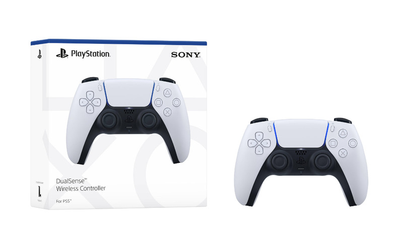 A white and black controller next to its box.
