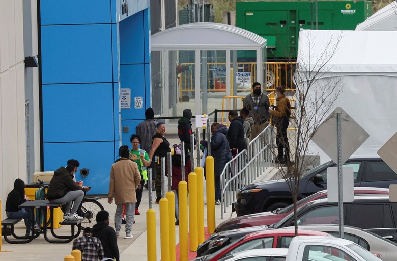 Amazon workers line up outside tents in the parking lot outside Amazon’s LDJ5 sortation center, as employees begin voting to unionize a second warehouse in the Staten Island borough of New York City, U.S. April 25, 2022. REUTERS/Brendan McDermid.