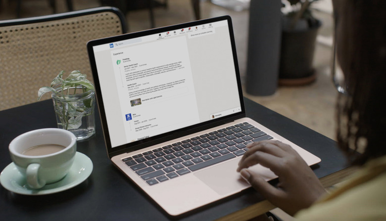 A laptop opened to a LinkedIn profile