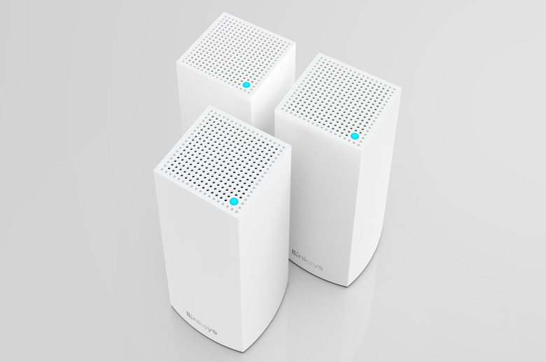 The rectangular Linksys Hydra 6 and Atlas 6 routers seen from above at a slight angle, as they're grouped together like a trio of little white skyscrapers.