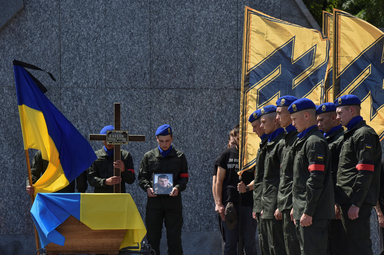 Members of the Ukrainian National Guard attend a funeral ceremony for their brother-in-arm Vasyl Sushchuk, the Azov regiment serviceman, who was killed in a fight against Russian troops in Mariupol city, as Russia's attack on Ukraine continues, in Lviv, Ukraine July 29, 2022. REUTERS/Pavlo Palamarchuk