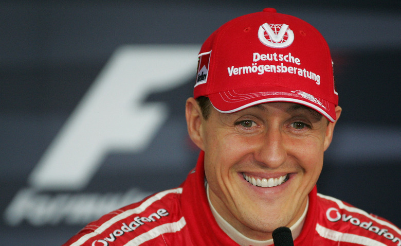 German Ferrari driver Michael Schumacher smiles during a press conference after the qualifiying session of the Bahrain Formula One Grand Prix at Sakhir racetrack, 11 March 2006, in Manama. AFP PHOTO DAMIEN MEYER (Photo by Damien MEYER / AFP) (Photo by DAMIEN MEYER/AFP via Getty Images)