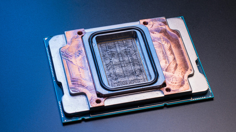 Image of a chip with intricate thread-like cooling pathways .