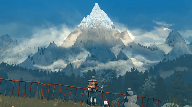A climber stares at a mountain.