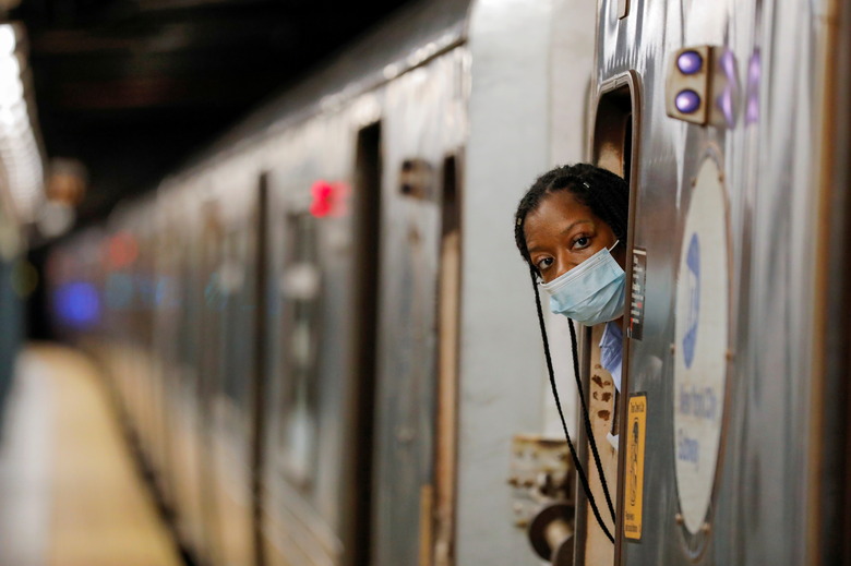 An MTA worker is seen wearing a mask on the subway after The Port Authority of New York and New Jersey and the Metropolitan Transportation Authority (MTA) announced a mandatory coronavirus vaccination or weekly test mandate for employees in New York City, New York, U.S., August 2, 2021. REUTERS/Andrew Kelly